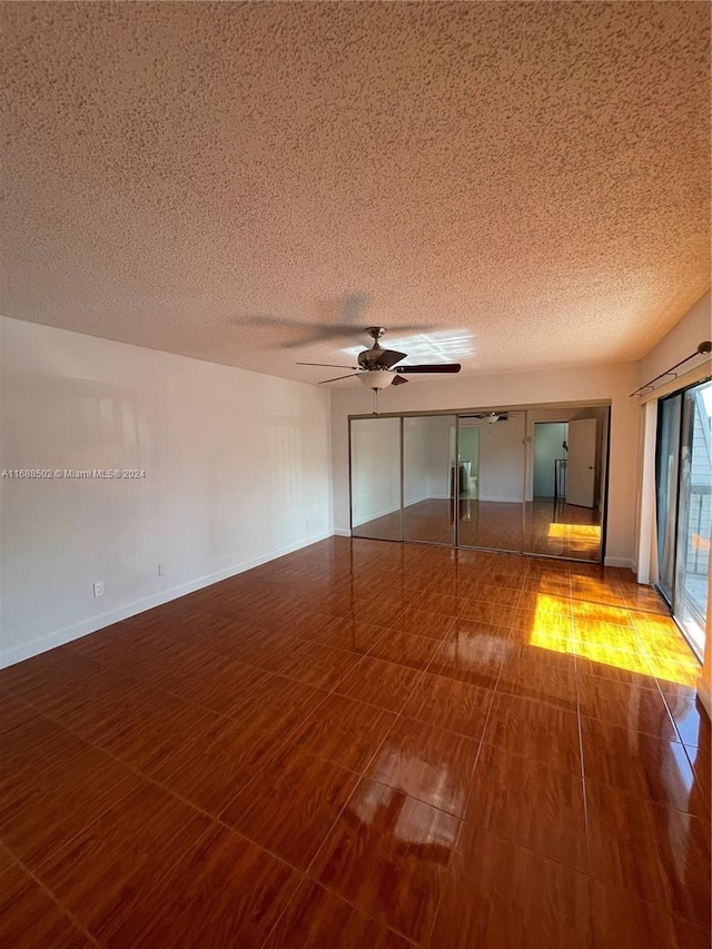 spare room featuring a textured ceiling and ceiling fan