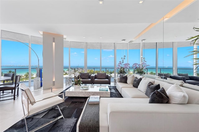 living room with a wall of windows, plenty of natural light, and a water view