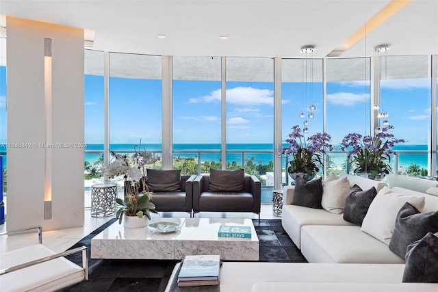 living room with a water view and floor to ceiling windows