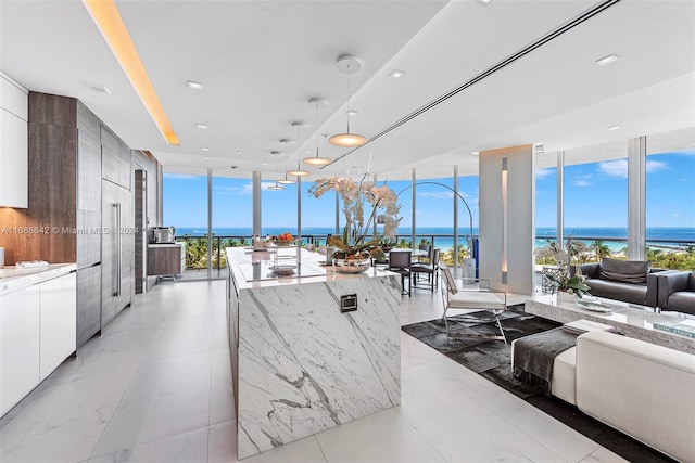 living room featuring a water view and floor to ceiling windows