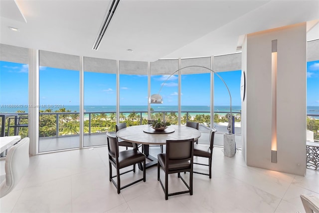 sunroom featuring a water view