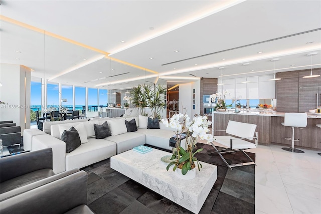 living room with expansive windows and a water view