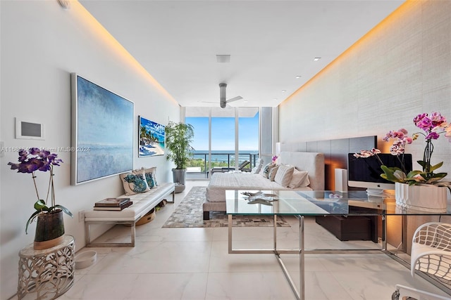 living room featuring floor to ceiling windows and ceiling fan