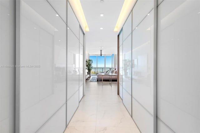 100 S Pointe Dr Unit 706, Miami Beach, FL 33139 - corridor featuring floor to ceiling windows and light marble finish flooring