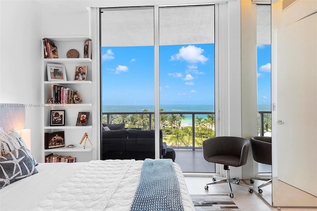 bedroom with wood-type flooring and a water view