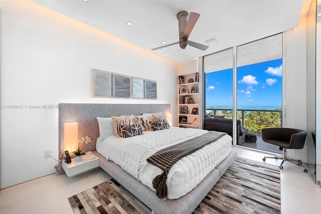 bedroom featuring access to exterior, expansive windows, and ceiling fan