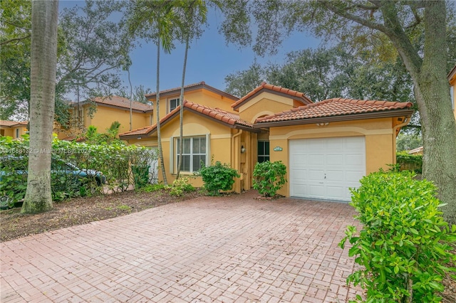 mediterranean / spanish-style home featuring a garage