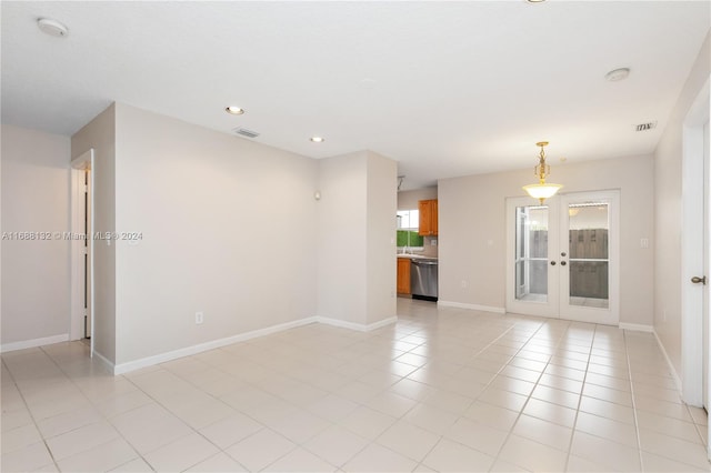 tiled empty room with french doors