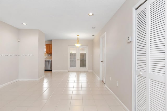 interior space featuring light tile patterned floors and french doors