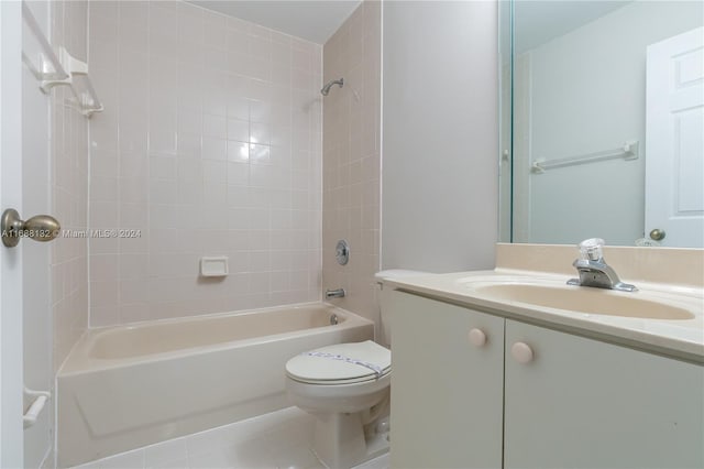 full bathroom featuring tile patterned flooring, vanity, toilet, and tiled shower / bath