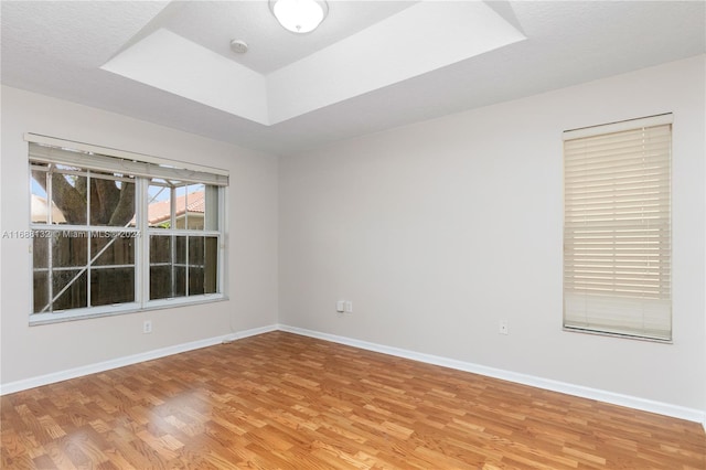 unfurnished room featuring hardwood / wood-style flooring and a textured ceiling