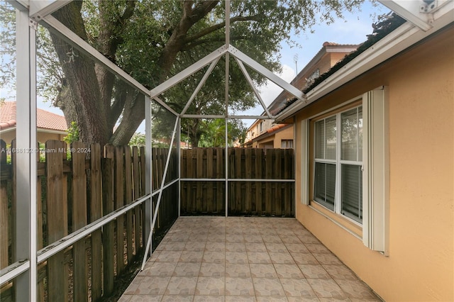 view of patio featuring a lanai