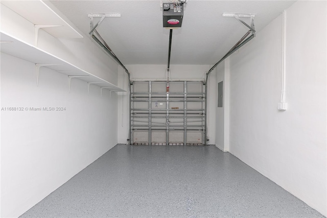 garage with a garage door opener and electric panel