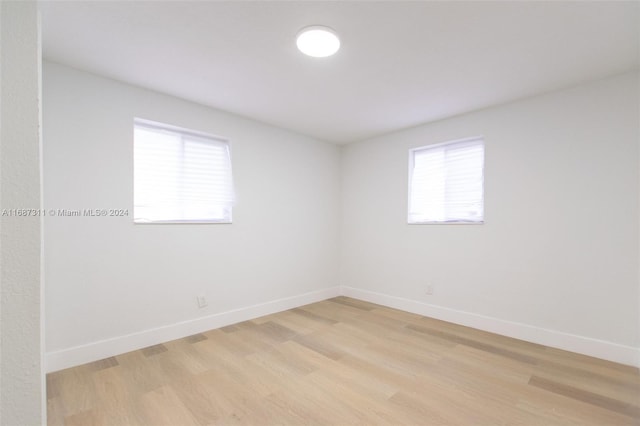 empty room with light hardwood / wood-style flooring