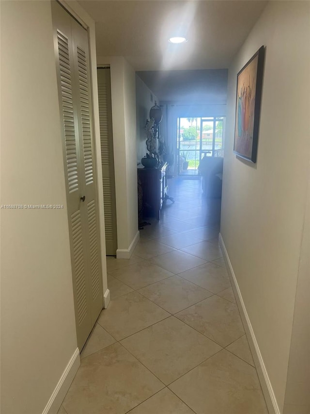 hallway with light tile patterned floors