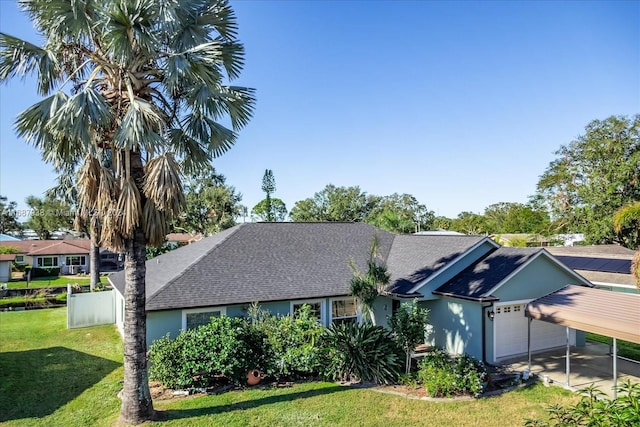 ranch-style house featuring a front lawn, a carport, and a garage