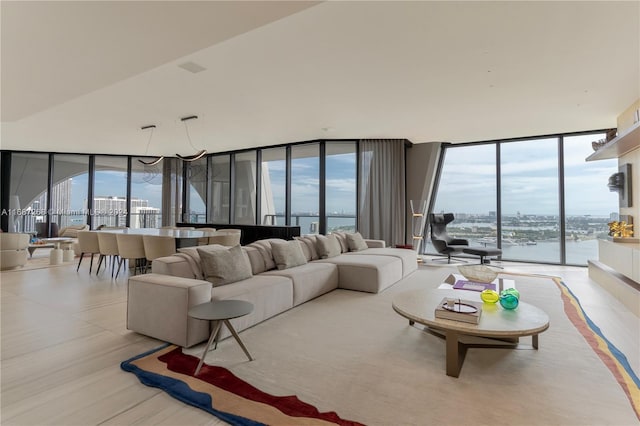 living room featuring a water view and floor to ceiling windows