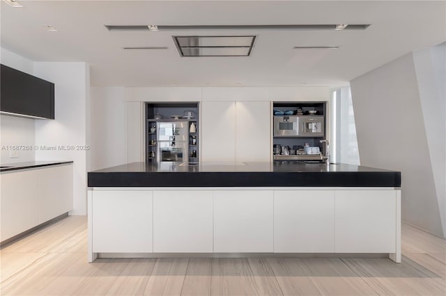 1000 Biscayne Blvd Unit 2702, Miami, FL 33132 - kitchen with dark countertops and white cabinets