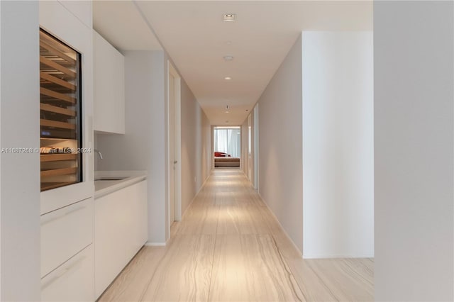 hall featuring sink and light wood-type flooring