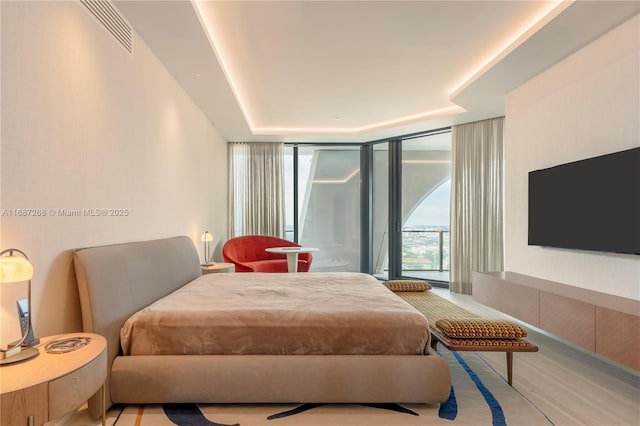 1000 Biscayne Blvd Unit 2702, Miami, FL 33132 - bedroom featuring a tray ceiling and a wall of windows