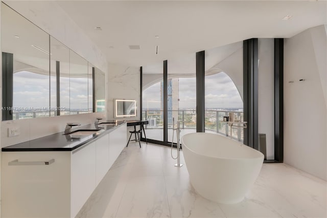 1000 Biscayne Blvd Unit 2702, Miami, FL 33132 - kitchen featuring plenty of natural light, a wall of windows, modern cabinets, white cabinets, and light marble finish floors