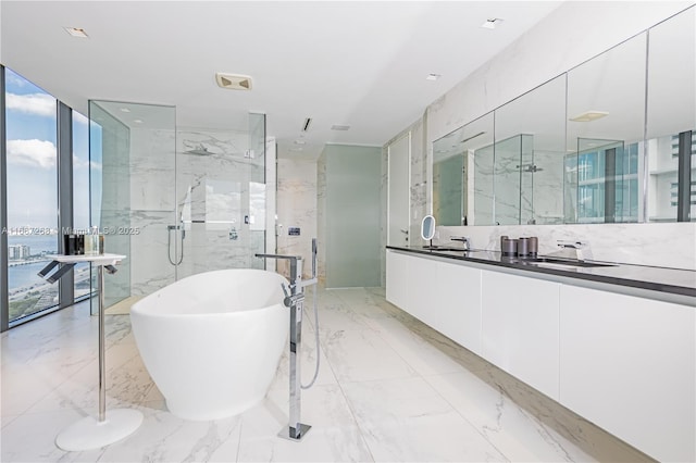 1000 Biscayne Blvd Unit 2702, Miami, FL 33132 - full bathroom featuring a freestanding tub, double vanity, a marble finish shower, marble tiled flooring, and expansive windows
