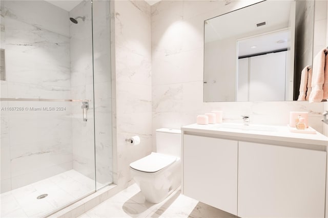 bathroom featuring vanity, toilet, tile walls, and a tile shower