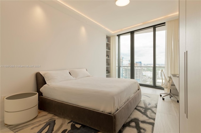 bedroom featuring floor to ceiling windows and access to exterior