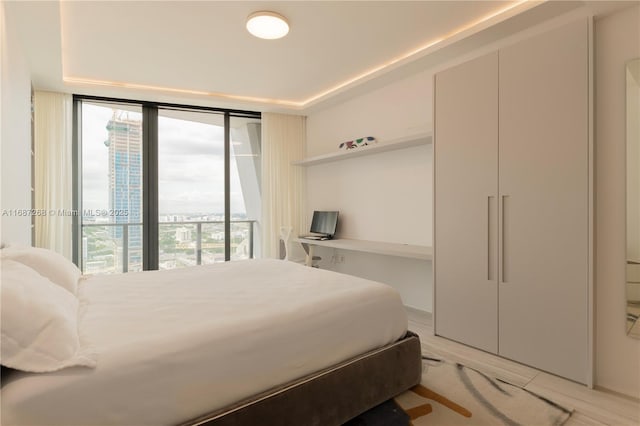 1000 Biscayne Blvd Unit 2702, Miami, FL 33132 - bedroom featuring multiple windows, access to exterior, light wood-style flooring, and a desk