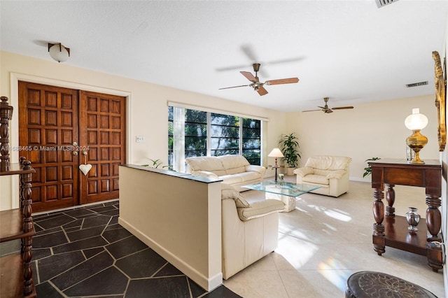 tiled living room featuring ceiling fan