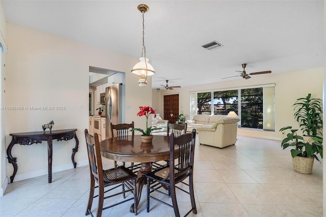 dining area featuring light tile patterned flooring and ceiling fan