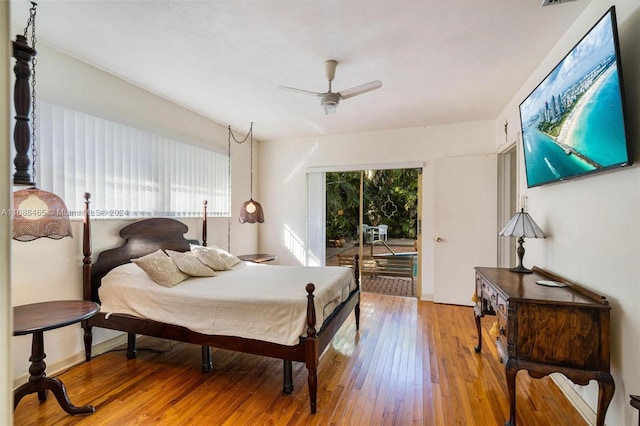 bedroom featuring access to outside, wood-type flooring, and ceiling fan