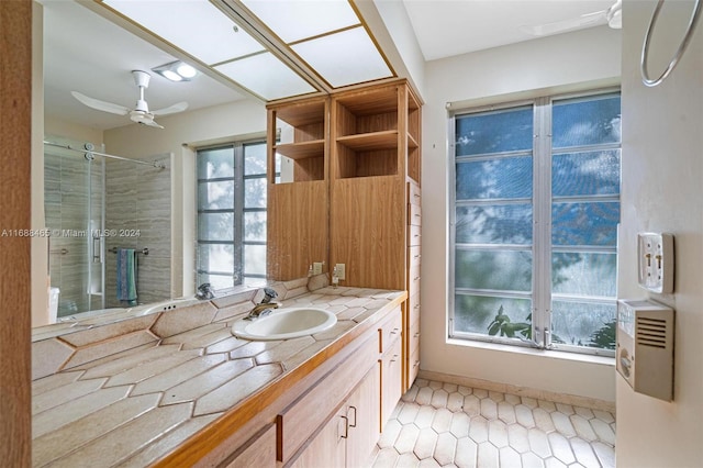 bathroom with ceiling fan, vanity, and an enclosed shower