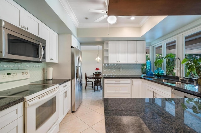 kitchen featuring stainless steel appliances, white cabinets, sink, tasteful backsplash, and light tile patterned flooring