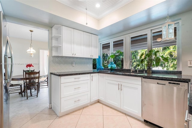 kitchen featuring backsplash, white cabinets, crown molding, and stainless steel appliances