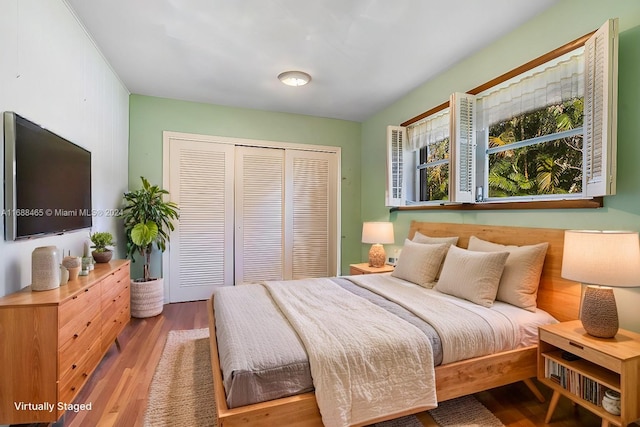 bedroom featuring hardwood / wood-style floors and a closet