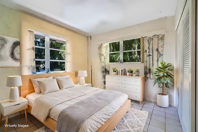 tiled bedroom featuring a closet