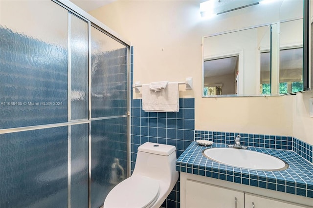 bathroom with an enclosed shower, vanity, and toilet