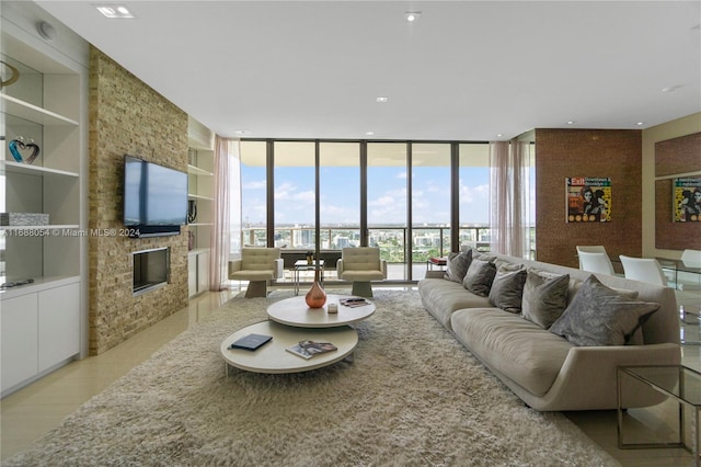 living room featuring built in shelves, floor to ceiling windows, and a fireplace