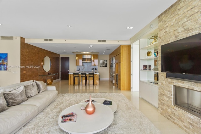 living room featuring built in shelves and light tile patterned flooring