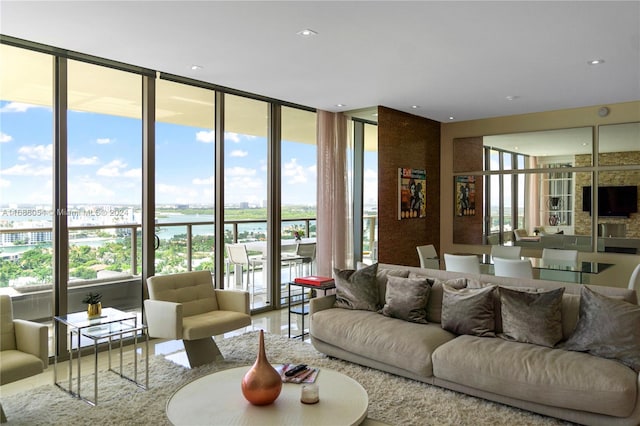 living room with a wall of windows, plenty of natural light, and a water view