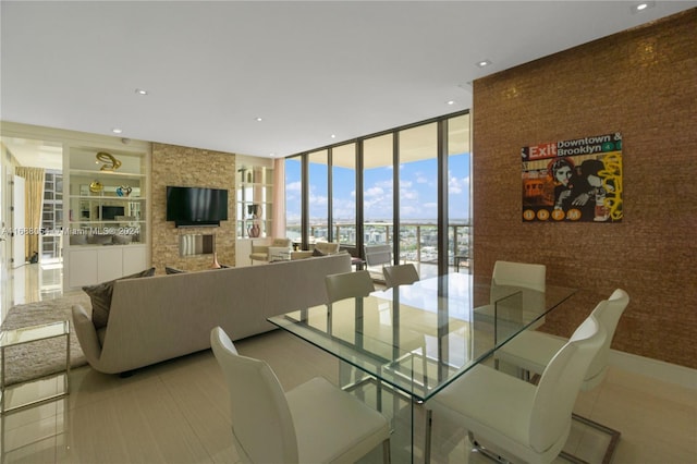 dining area with built in shelves, light tile patterned flooring, and floor to ceiling windows