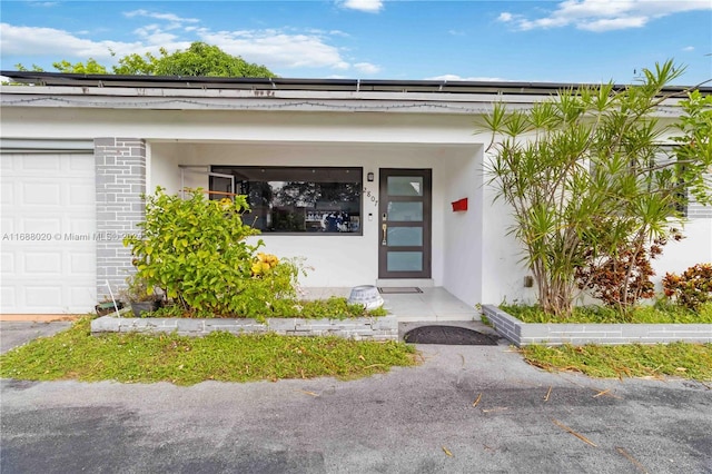 view of exterior entry with a garage