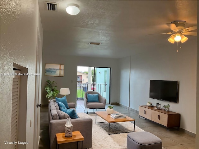 tiled living room with ceiling fan