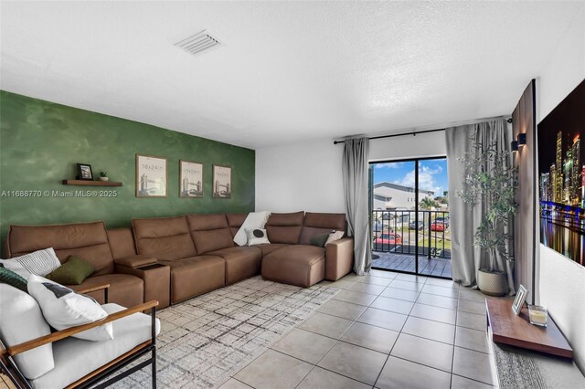 tiled empty room featuring ceiling fan and a textured ceiling