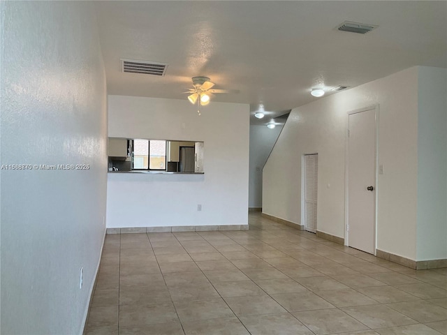 unfurnished living room with ceiling fan and light tile patterned floors