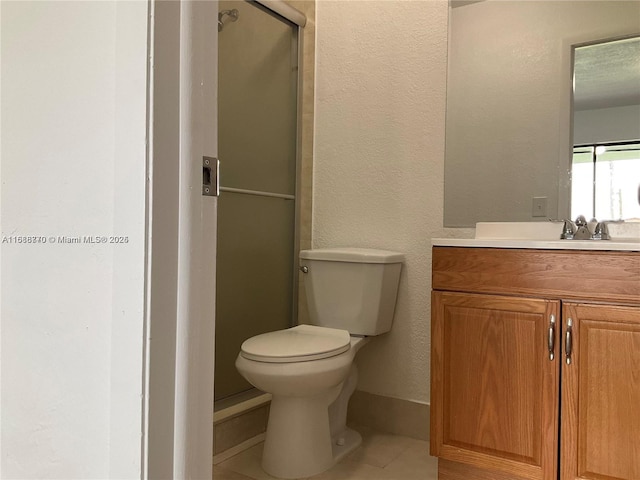 bathroom with vanity, an enclosed shower, tile patterned floors, and toilet