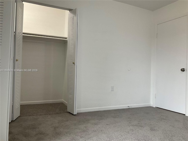 unfurnished bedroom with carpet floors and a closet