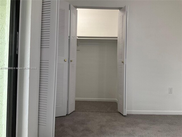 unfurnished bedroom featuring a closet and carpet flooring