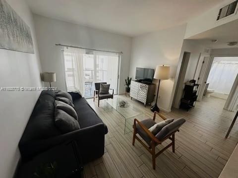 living room with light hardwood / wood-style flooring